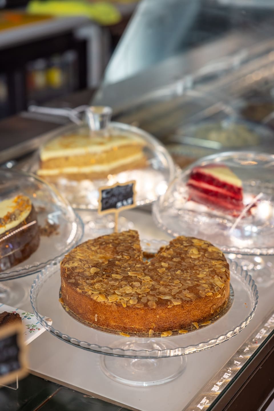 Homemade cakes under glass domes on the counter