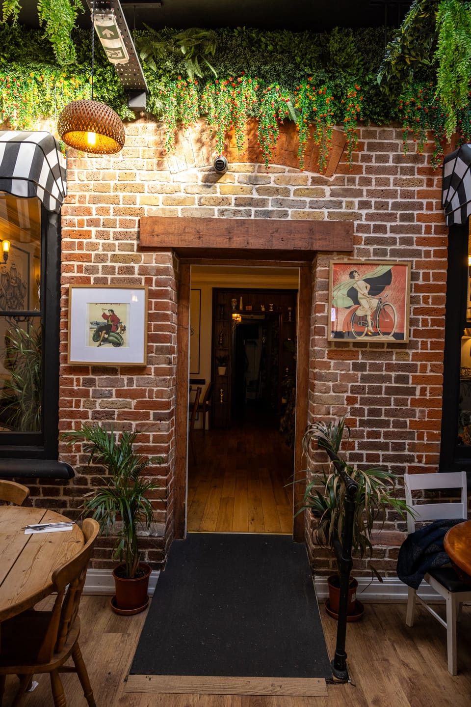The brick-arched doorway between the two rooms